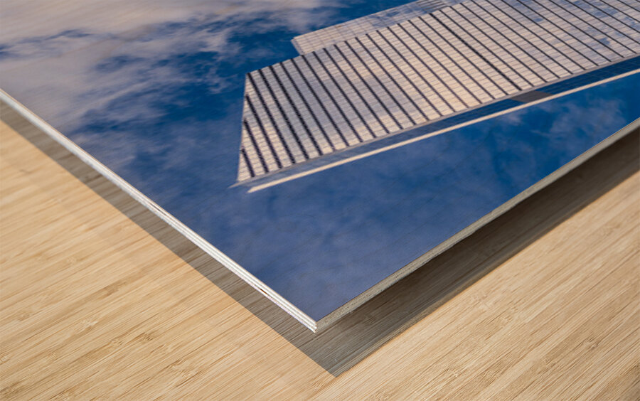 Looking up at modern buildings by brick chimney in Hudson Yards Wood print