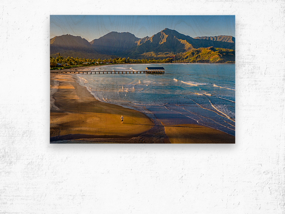 Aerial drone shot of man on the sand of Hanalei beach  Wood print