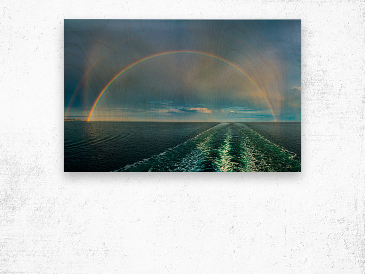 Dramatic double rainbow over wake of ship Wood print